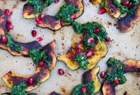 Golden Roasted Acorn Squash with Zesty Arugula Pesto and Pomegranate Gems