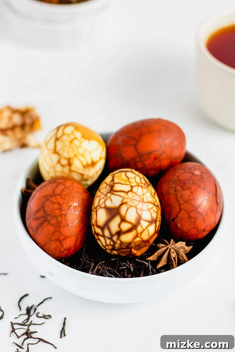 Taiwan's Fragrant Marbled Eggs 2 Marbled Taiwanese tea eggs on a bed of loose black tea in a white bowl