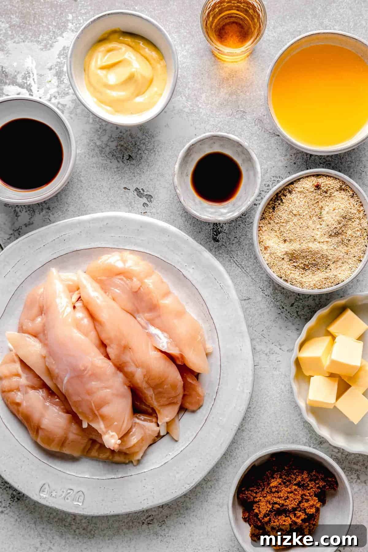 All the essential ingredients for making delicious bourbon chicken, carefully portioned and ready for preparation. Individual ingredients for homemade bourbon chicken separated into small bowls on a wooden cutting board, showcasing fresh components for the recipe.