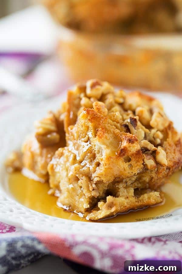 Easy Make-Ahead Eggnog French Toast for Holiday Brunch A close-up view of the custardy interior and toasted crust of the Overnight Eggnog French Toast Bake, showcasing its delicious texture.