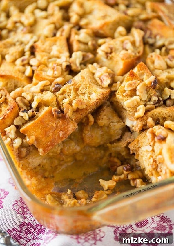 Best Overnight French Toast Recipe with Eggnog and Walnuts A perfectly baked Overnight Eggnog French Toast Bake, lightly dusted with powdered sugar, highlighting its golden exterior and inviting appeal.