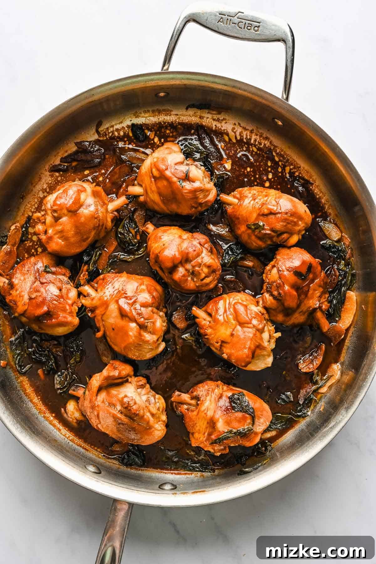 This authentic Taiwanese recipe for three cup chicken (三杯雞) is easy enough to make at home, so you won't have to get it from a restaurant! Three cup chicken in a skillet.