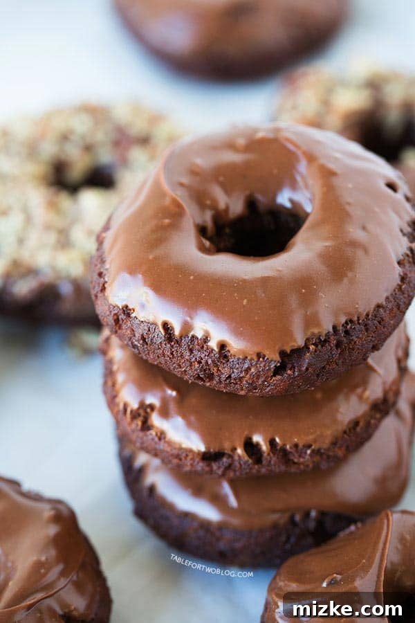 Homemade Double Chocolate Donuts Stack Stacked chocolate chocolate donuts, showcasing the rich ganache glaze and cakey texture, ready to be enjoyed