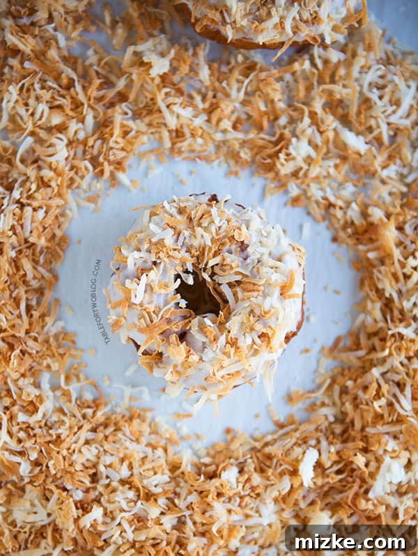 Close-up of a fresh Triple Coconut Donut showing its tender texture