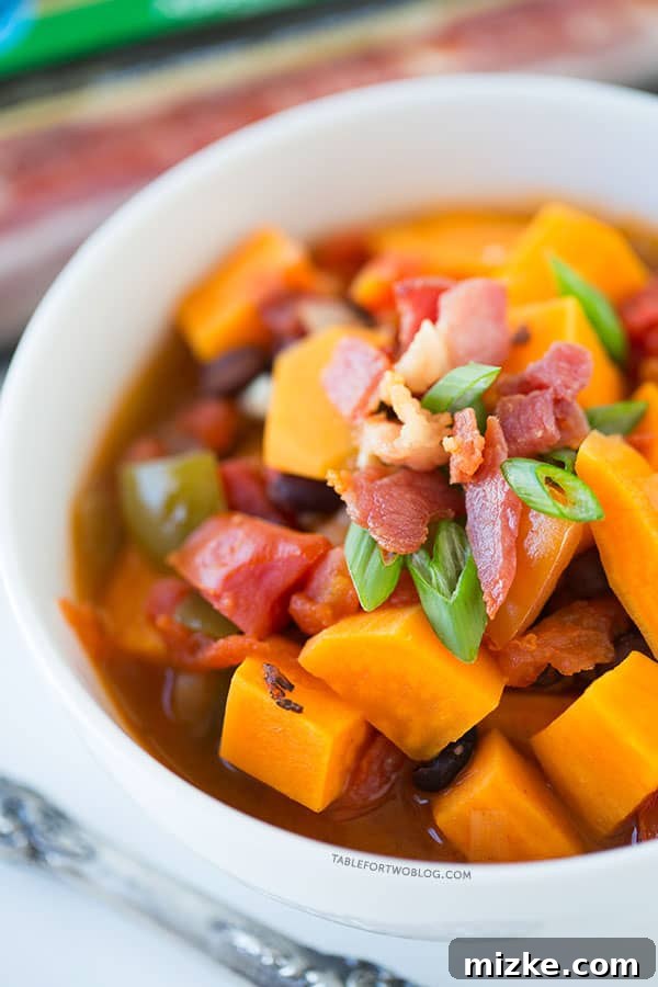 Wholesome Sweet Potato, Black Bean, and Bacon Chili Close-up of a bowl of Sweet Potato, Black Bean, and Bacon Chili, showcasing its rich texture and colors.