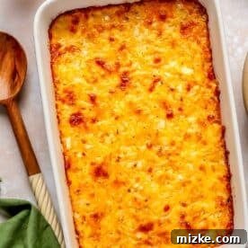 Irresistible Cheesy Hashbrown Bake 8 The baked cheesy hashbrown casserole with a rich, browned cheese topping, indicating it's perfectly cooked.