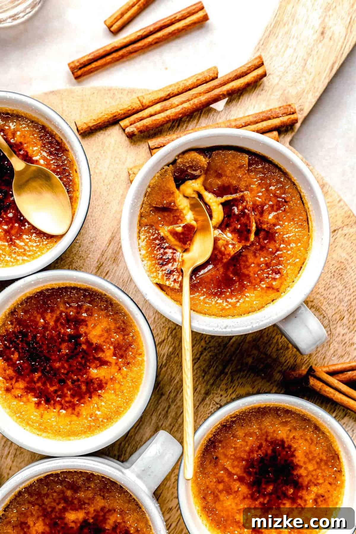 Creamy, restaurant-quality pumpkin creme brulee is infused with just the right amount of pumpkin & has the perfect caramelized sugar topping. Close-up detailed image of a single ramekin of pumpkin creme brulee with a perfectly torched sugar crust.