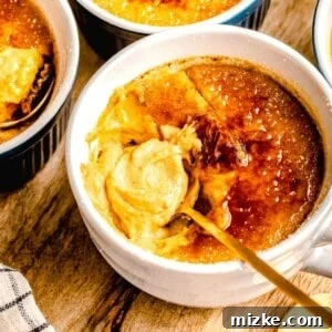 A spoon taking a bite out of pumpkin creme brulee.