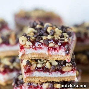 A close-up of a raspberry coconut bar with a golden crust, rich coconut layer, and vibrant raspberry jam, promising a delightful treat.