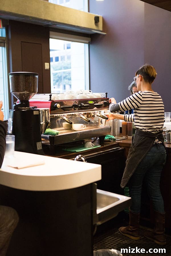 Expert Barista at Caffé Medici A baristas preparing coffee at Caffé Medici with precision and care.