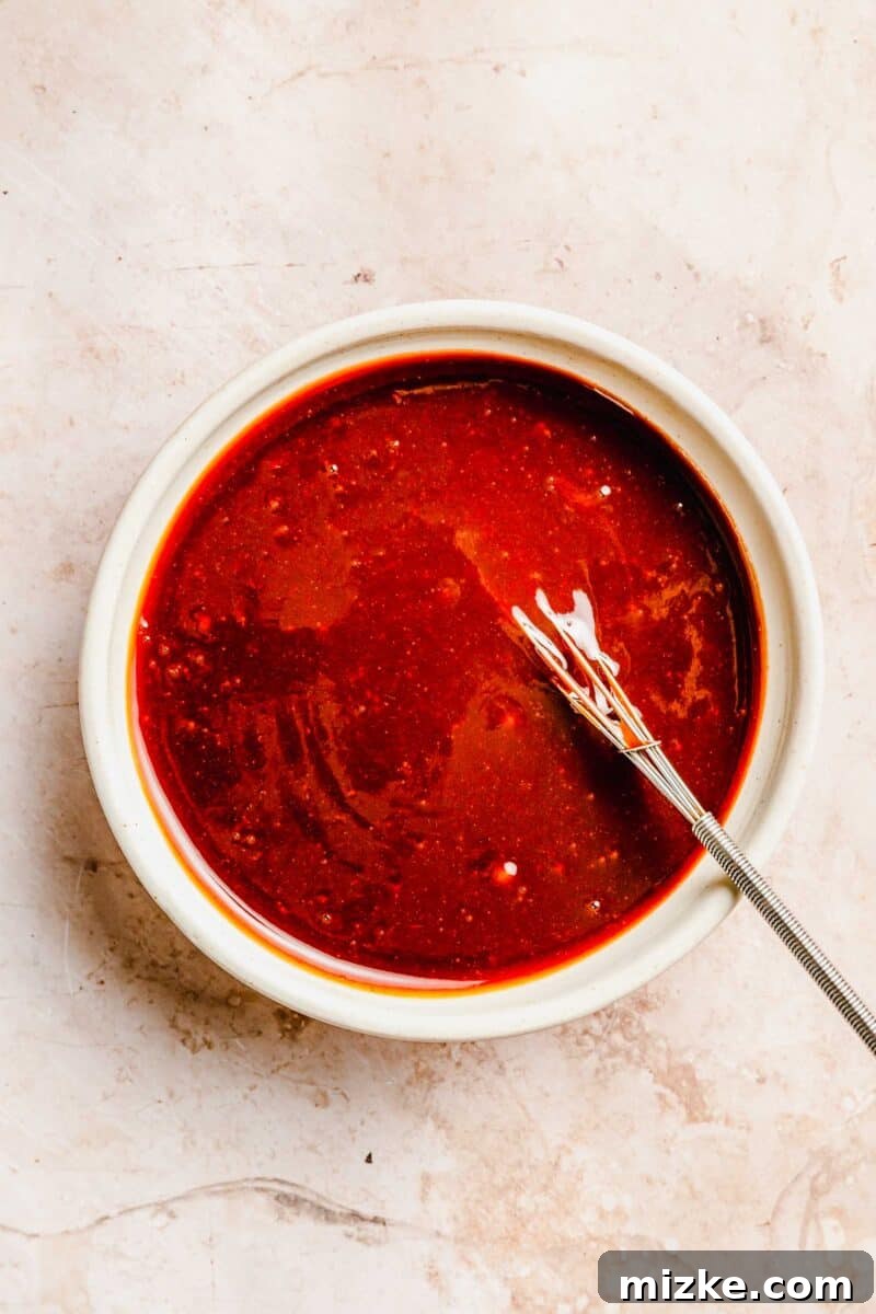 Prepare the essential sweet and tangy glaze for your classic meatloaf, combining ketchup, brown sugar, Worcestershire, and vinegar. Ingredients for the sweet and tangy glaze combined in a small bowl, showing its rich texture.