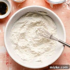 Flour mixture in a small bowl with a metal whisk, ready to be combined.