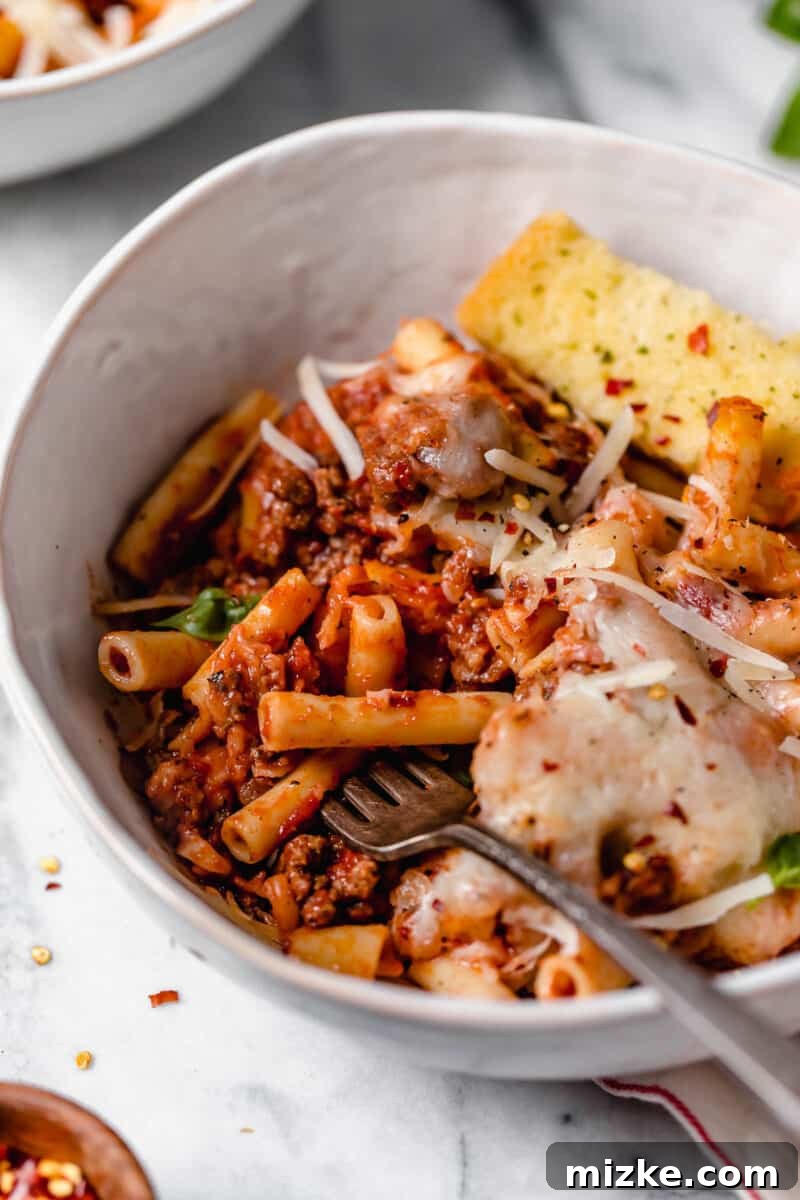 Ultimate Baked Ziti 6 Top-down view of a large baking dish filled with Baked Ziti, garnished with fresh basil, ready to be served