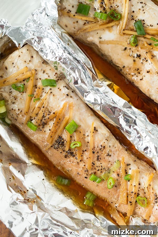 Foil packet fish ready for oven A foil packet sealed, ready for baking in the oven for a tender, flaky fish meal.