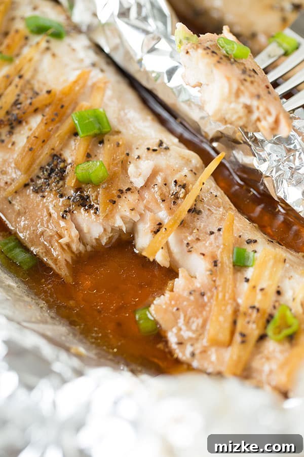 Unwrapping baked fish in a pouch Carefully unwrapping a baked Ginger Soy Sesame Fish in a Pouch, steam rising deliciously.