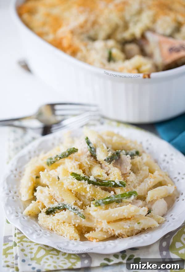 A close-up of a freshly baked Roasted Asparagus and Chicken Penne Bake, ready to be served. Delicious Roasted Asparagus and Chicken Penne Bake, a perfect spring dish.