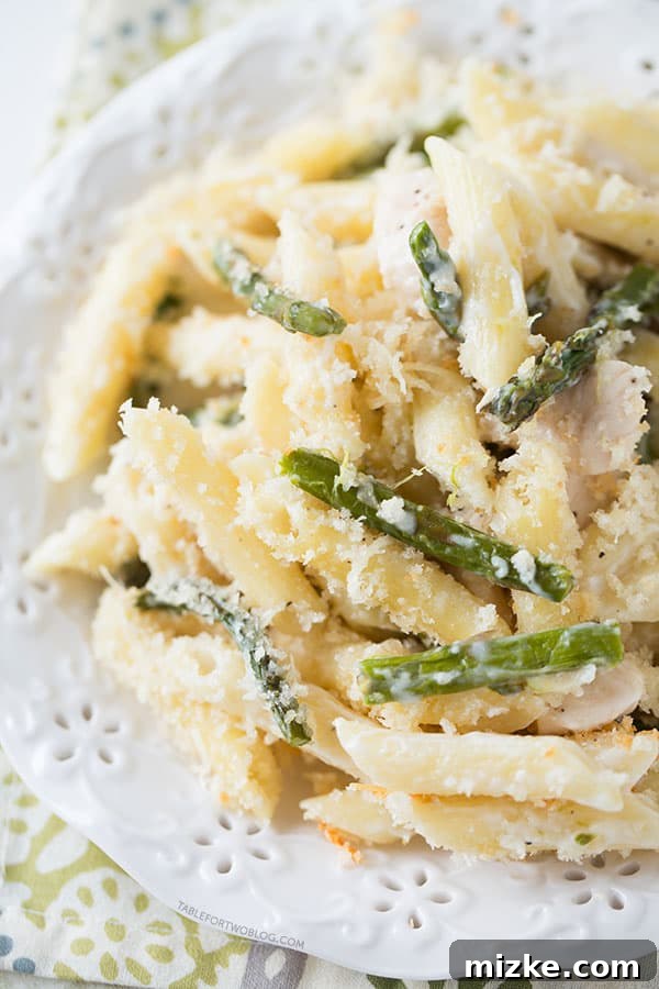 Enjoying a serving of the delightful Roasted Asparagus and Chicken Penne Bake. A vibrant bowl of Roasted Asparagus and Chicken Penne Bake, showcasing the fresh ingredients.