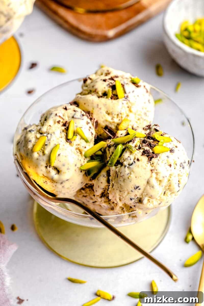 Velvet Pistachio Dream 2 Pistachio ice cream served in a bowl with a spoon, highlighting its creamy texture and pistachio pieces.