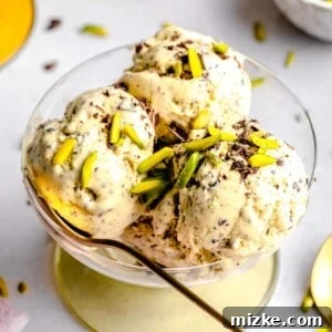 Pistachio ice cream served in a bowl with a spoon.