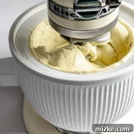 Churning pistachio ice cream in an ice cream maker.