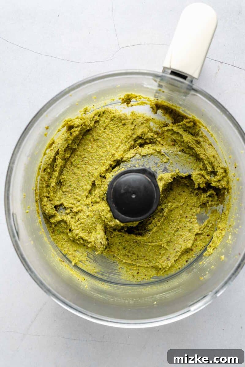 Velvet Pistachio Dream 4 Pistachio paste being made in a food processor, showing the sandy texture.