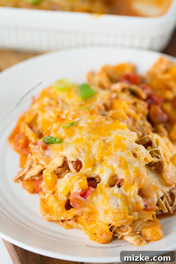 Sky High Chicken Enchiladas 5 A generous serving of stacked chicken enchiladas on a plate, showcasing its comforting layers