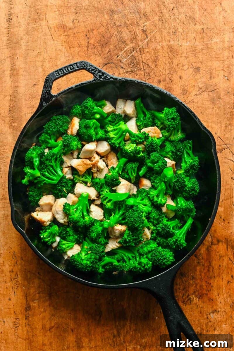 This 20-minute teriyaki chicken and broccoli recipe is made with juicy chicken and tender broccoli. It's healthy and better than takeout! Cubed chicken and broccoli combined in a skillet.