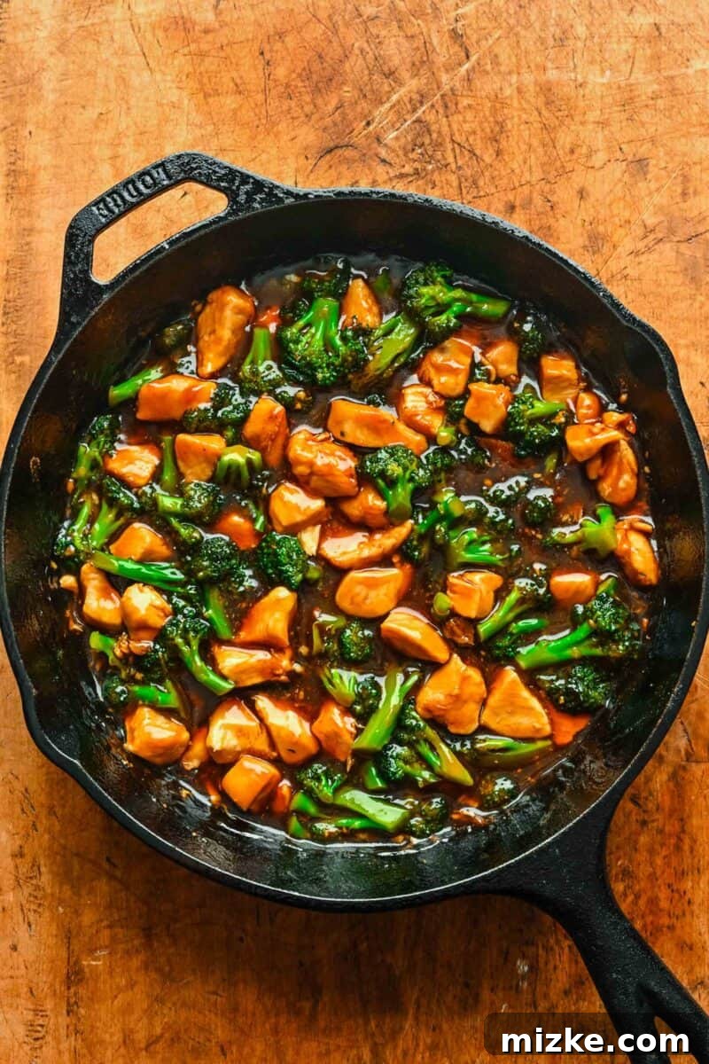 This 20-minute teriyaki chicken and broccoli recipe is made with juicy chicken and tender broccoli. It's healthy and better than takeout! Cooked chicken and broccoli tossed with teriyaki sauce in a skillet.