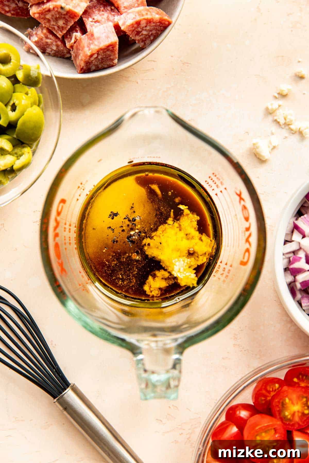 Dressing Ingredients Close-up shot of olive oil, balsamic vinegar, minced garlic, and seasonings meticulously measured in a glass measuring cup, ready to be whisked into the dressing.