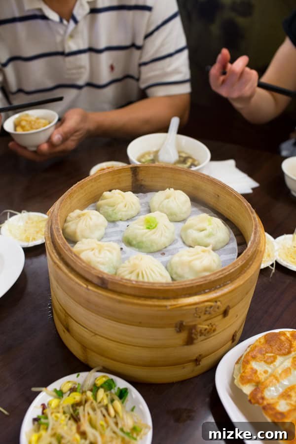 Various Taiwanese dishes including soup dumplings and potstickers on a table