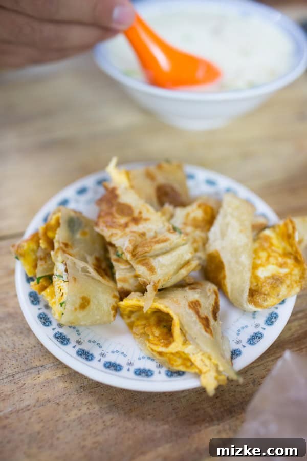 Freshly made scallion pancakes with egg, a popular Taiwanese breakfast item