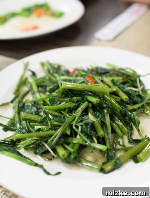 Kaohsiung: Taiwan's Vibrant Southern Hub 3 Close-up of freshly stir-fried watercress spinach, a popular and healthy Taiwanese vegetable dish