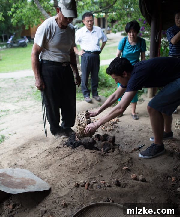 Hsinchu: Taiwan's Innovation Nexus 18 The process of knocking down the hot rock structure and covering the pit with dirt to cook the food.