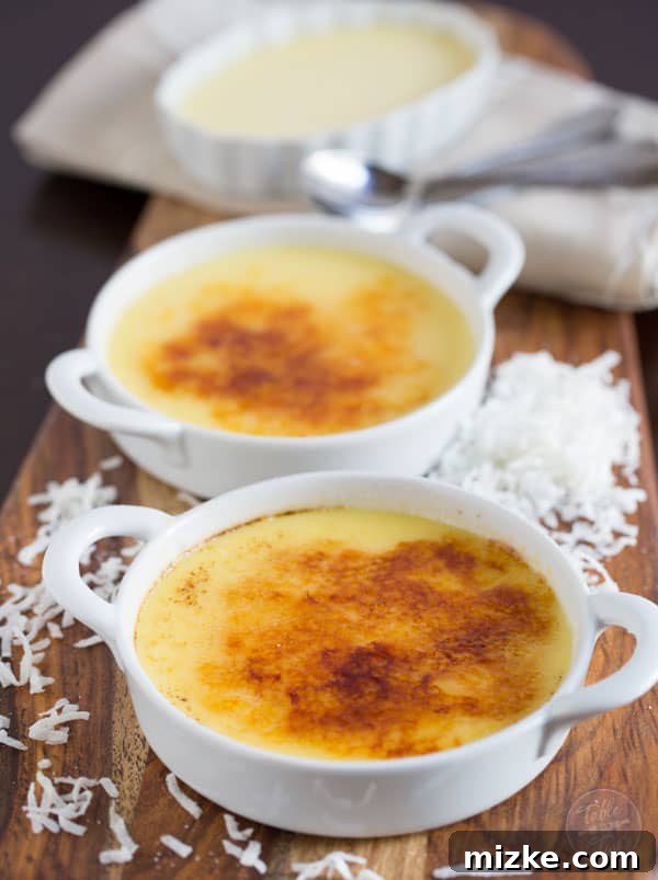 Paradise Coconut Creme Brulee 2 Exquisitely creamy Coconut Crème Brûlée, artfully garnished and ready to be enjoyed.