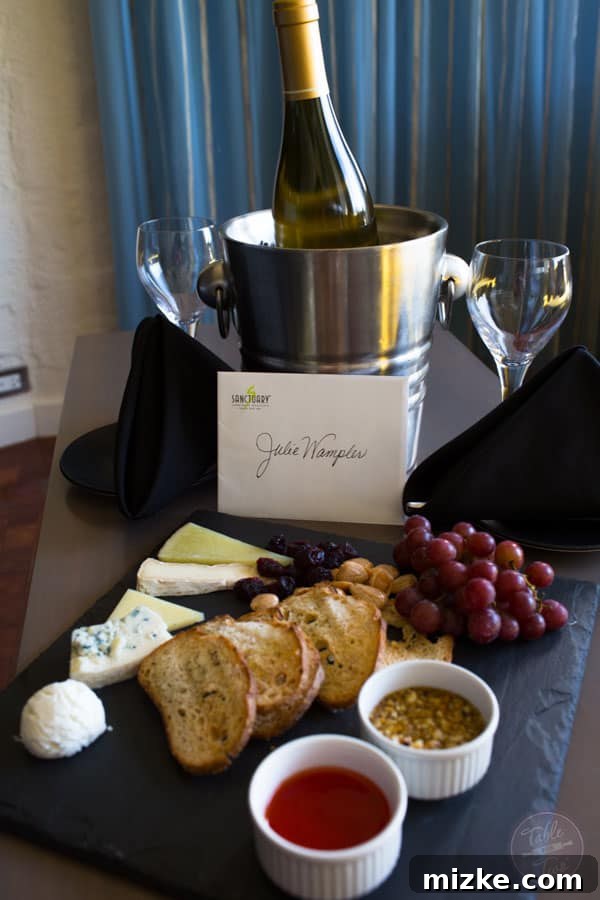 Delicious fruit and cheese platter with white wine in a luxury suite