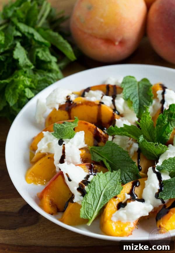 Caramelized Peach Burrata Bliss 4 Overhead view of grilled peaches with burrata, mint leaves, and a generous drizzle of balsamic glaze, ready to be served.
