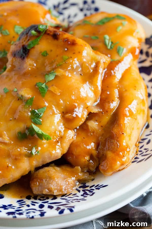 Russian Apricot Chicken with a Sweet-Tangy Glaze 5 A baking dish filled with 4-ingredient Russian Apricot Chicken, featuring boneless, skinless chicken thighs marinated in a vibrant, sweet, and tangy sauce before baking.