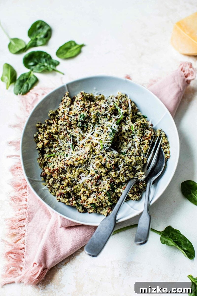 Overhead shot of the spinach pesto quinoa bowl, garnished and ready to eat.