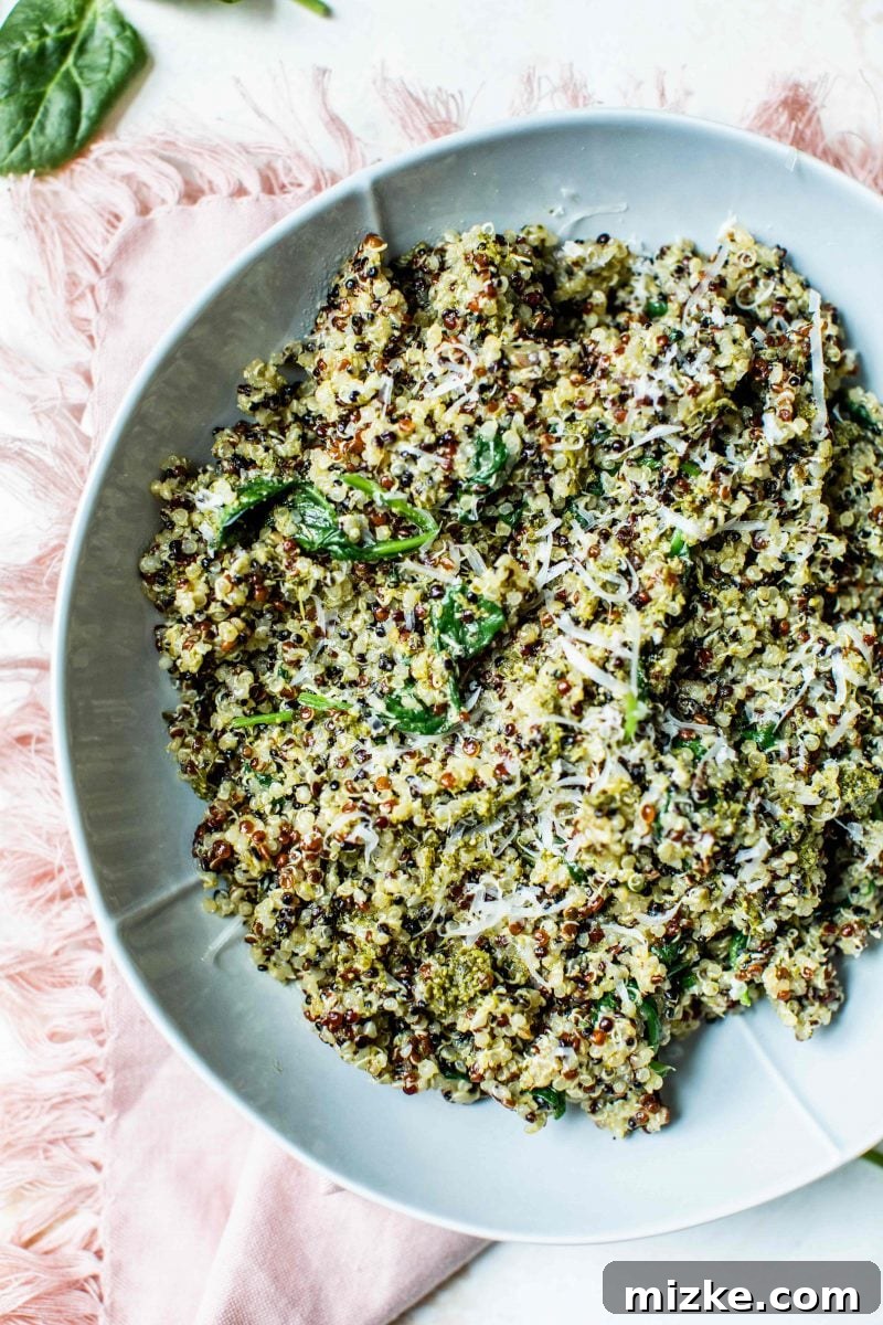 A close-up of the spinach pesto quinoa bowl with a fork, ready to be eaten.