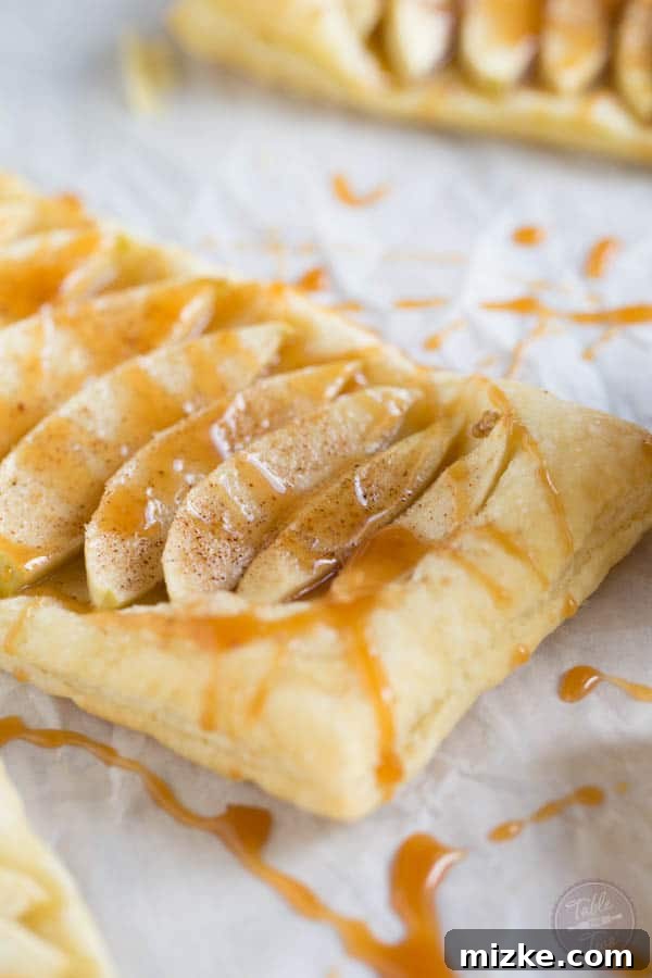 Sea Salt Caramel Apple Tarts 5 Multiple salted caramel apple tarts artfully arranged, ready to be served, highlighting their inviting appeal.