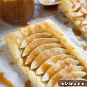 A stunning salted caramel apple tart, ready to be enjoyed, showcasing golden pastry and rich caramel.