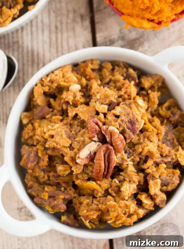 Cozy Pumpkin Spice Baked Oatmeal 4 A close-up of a rustic square baking dish filled with golden-brown pumpkin spice baked oatmeal, garnished with nuts and ready to be served.