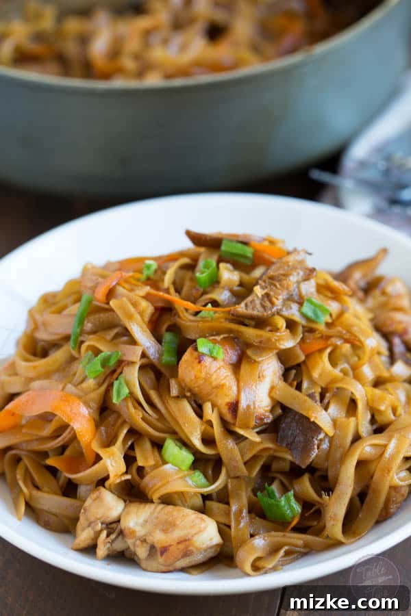 THAI CHICKEN CURRY NOODLE BOWLS 5 Overhead view of Thai Chicken Curry Noodles in a skillet during cooking