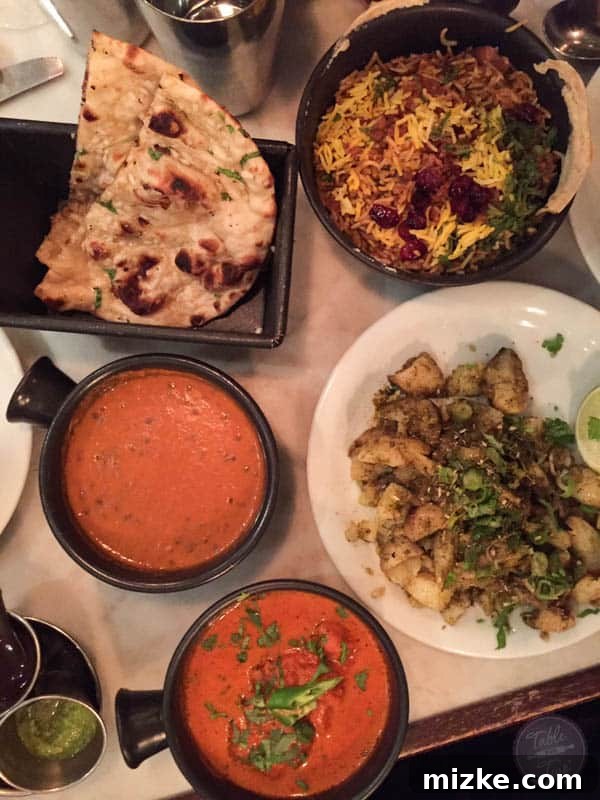 Dishoom Feast: Indian Culinary Excellence A spread of delicious Indian dishes from Dishoom: garlic naan, biryani, daal, curries
