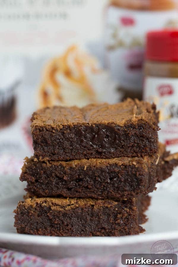 Caramelized Cookie Butter Swirl Brownies 3 A top-down view of delectable fudgy Biscoff swirl brownies, emphasizing the artful blend of dark chocolate and creamy Biscoff, making for an irresistible treat.
