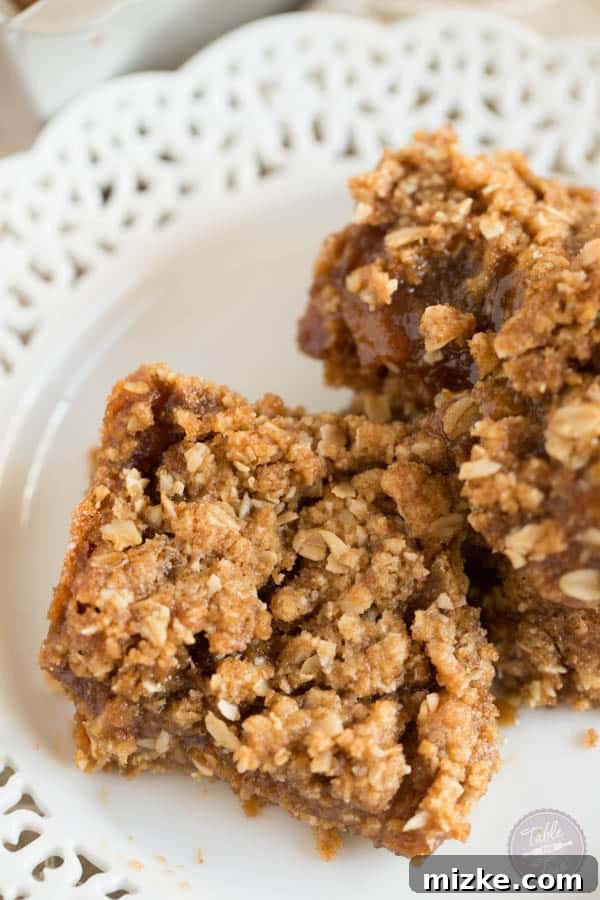 Salted Caramel Apple Butter Delights 3 A close-up of baked apple butter salted caramel bars, showcasing the gooey filling and crumbly topping.