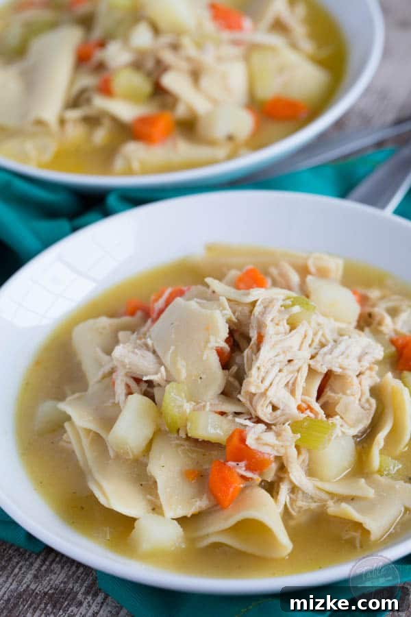 Amish Country Chicken Pot Pie 3 Close-up of square pot pie noodles simmering in a rich chicken and vegetable broth for Pennsylvania Dutch Chicken Pot Pie.