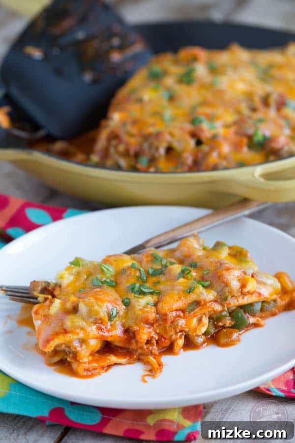 Sunrise Enchilada Stack 2 A vibrant close-up of Stacked Breakfast Enchiladas featuring layers of melted cheese and a rich red sauce, ready to be served.