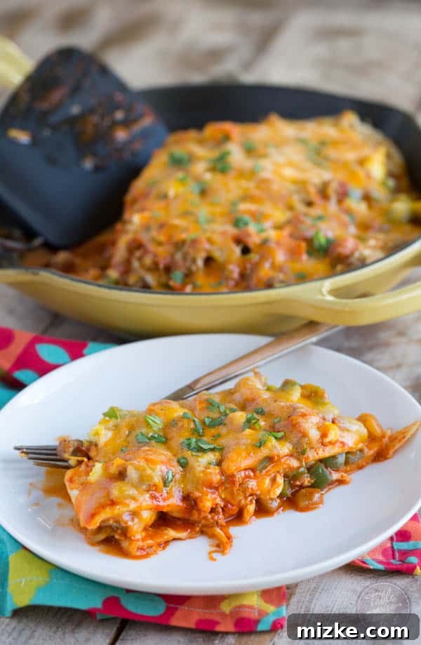 Sunrise Enchilada Stack 4 A slice of Stacked Breakfast Enchiladas, showing off the perfectly layered ingredients and the rich texture of the dish.