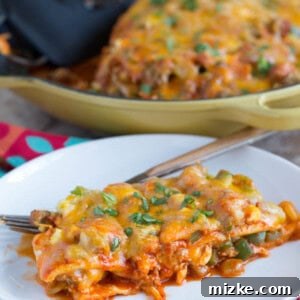 Finished Stacked Breakfast Enchiladas dish in a cast iron skillet.
